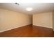 The spacious living room has neutral colored walls and wood floors at 37712 Aaralyn Rd, Zephyrhills, FL 33542