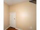 Neutral room with hardwood floors, a door, and an electrical outlet, ready for customization at 37712 Aaralyn Rd, Zephyrhills, FL 33542