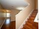 Hardwood stairs lead up to the next level, connecting living spaces with style and sophistication at 37712 Aaralyn Rd, Zephyrhills, FL 33542