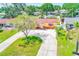 Scenic aerial view of a charming single-story home with lush greenery and a curved driveway at 4360 82Nd N Ave, Pinellas Park, FL 33781