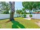 Well-maintained backyard features lush greenery, mature trees, and a privacy fence for a serene outdoor space at 4360 82Nd N Ave, Pinellas Park, FL 33781