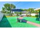 Expansive backyard featuring artificial turf, a screened pool, and outdoor seating areas for relaxation and entertainment at 4360 82Nd N Ave, Pinellas Park, FL 33781