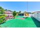 Inviting backyard featuring a screened pool area, outdoor seating, artificial turf, and privacy fence, perfect for outdoor living at 4360 82Nd N Ave, Pinellas Park, FL 33781