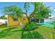 Backyard featuring mature landscaping that enhances the colorful painted home at 4360 82Nd N Ave, Pinellas Park, FL 33781