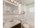 Well-maintained bathroom with a vanity, toilet, and shower with a daisy-patterned curtain at 4360 82Nd N Ave, Pinellas Park, FL 33781