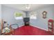 Small bedroom with bright red carpet, two windows, and a ceiling fan at 4360 82Nd N Ave, Pinellas Park, FL 33781