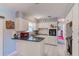 Bright kitchen featuring white cabinets, black countertops, and stainless steel sink offers an inviting space at 4360 82Nd N Ave, Pinellas Park, FL 33781