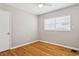 Bedroom with hardwood floors, a ceiling fan, and a door to the left at 4512 S Lois Ave, Tampa, FL 33611