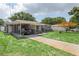 Charming single-story home featuring a covered parking area, and lush landscaping at 4512 S Lois Ave, Tampa, FL 33611