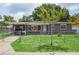 Charming single-story home featuring a fenced front yard, covered parking and beautiful landscaping at 4512 S Lois Ave, Tampa, FL 33611