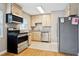 Updated kitchen with stainless steel appliances, granite countertops, and ample cabinetry at 4512 S Lois Ave, Tampa, FL 33611