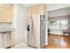 Bright kitchen with stainless steel refrigerator, ample cabinet storage, and an open layout at 4512 S Lois Ave, Tampa, FL 33611