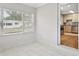 Bright sunroom with tile floor, large window, and view into kitchen at 4512 S Lois Ave, Tampa, FL 33611