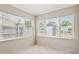 This light filled sunroom features large windows and a tile floor at 4512 S Lois Ave, Tampa, FL 33611