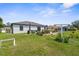 View of the back of the house with backyard, patio and large garden bed at 4831 Hillman Ter, North Port, FL 34288