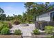 Backyard patio featuring a fire pit and outdoor seating area with mature landscaping at 4831 Hillman Ter, North Port, FL 34288