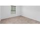 A cozy bedroom featuring neutral carpet and a window at 4831 Hillman Ter, North Port, FL 34288