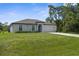 Inviting single-Gathering home featuring green lawn, neutral stucco and attached garage at 4831 Hillman Ter, North Port, FL 34288