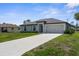 A well-kept single-story home with a long driveway and attached two-car garage at 4831 Hillman Ter, North Port, FL 34288