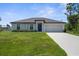 Charming single-story home with a well-manicured lawn and a neutral-colored facade at 4831 Hillman Ter, North Port, FL 34288