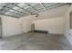 Spacious two-car garage with an overhead door and concrete flooring at 4831 Hillman Ter, North Port, FL 34288