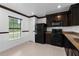 A well-lit kitchen with black appliances and dining space next to a sunny window at 4831 Hillman Ter, North Port, FL 34288