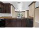 Kitchen featuring dark cabinets, stainless steel sink, and backyard view at 4831 Hillman Ter, North Port, FL 34288