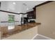 Kitchen with granite countertops and black appliances at 4831 Hillman Ter, North Port, FL 34288