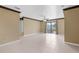 Expansive living room boasts neutral paint, tile flooring, and natural light through sliding glass doors at 4831 Hillman Ter, North Port, FL 34288