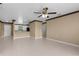 Open-concept living area with tiled floors, a ceiling fan, and connection to the kitchen at 4831 Hillman Ter, North Port, FL 34288