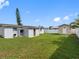 Expansive backyard features lush lawn, storage shed, and an exterior view of the home at 4925 Murray Hill Dr, Tampa, FL 33615