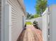 Sideyard deck with an enclosed fence to a grass lawn and potted plants under a bright, sunny sky at 4925 Murray Hill Dr, Tampa, FL 33615