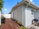 Exterior back of home with deck and small BBQ, potted plants, and partial fence at 4925 Murray Hill Dr, Tampa, FL 33615