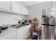 Kitchen with marble countertop, double sink, stainless steel refrigerator, and plenty of storage at 4925 Murray Hill Dr, Tampa, FL 33615