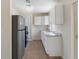 Well-lit kitchen featuring stainless steel refrigerator and ample counter space at 4925 Murray Hill Dr, Tampa, FL 33615