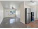 Open floor plan living room with adjacent kitchen featuring stainless steel appliances at 4925 Murray Hill Dr, Tampa, FL 33615