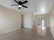 Living room with neutral wall color and shiny floors next to adjacent eat-in kitchen at 4925 Murray Hill Dr, Tampa, FL 33615