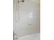 Bathroom shower featuring neutral tile surround, detachable head, and chrome fixtures at 4925 Murray Hill Dr, Tampa, FL 33615