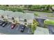 Aerial view of multi-story condos and a paved parking lot shaded by mature trees along a quiet street at 501 Knights Run Ave # 6104, Tampa, FL 33602