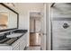 Bathroom features granite countertop vanity, white cabinets, and an enclosed glass shower at 501 Knights Run Ave # 6104, Tampa, FL 33602