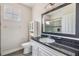 Bathroom features granite countertop vanity, white cabinets, and an enclosed glass shower at 501 Knights Run Ave # 6104, Tampa, FL 33602