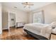 Bright bedroom features hardwood floors, a ceiling fan, and access to a private balcony at 501 Knights Run Ave # 6104, Tampa, FL 33602