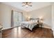 Relaxing bedroom with wood floors, a queen-sized bed, and french doors offering natural light at 501 Knights Run Ave # 6104, Tampa, FL 33602