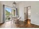 Bright dining area featuring modern light fixture, glass table, and balcony access with scenic view at 501 Knights Run Ave # 6104, Tampa, FL 33602