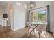 Bright dining room with modern table, hardwood floors, and sliding glass door to private balcony at 501 Knights Run Ave # 6104, Tampa, FL 33602