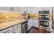 Updated kitchen featuring stainless steel appliances, granite countertops, and decorative mosaic backsplash at 501 Knights Run Ave # 6104, Tampa, FL 33602