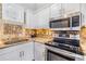 Bright kitchen featuring stainless steel appliances, granite countertops, and stylish mosaic backsplash at 501 Knights Run Ave # 6104, Tampa, FL 33602