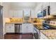 Well-lit kitchen with stainless steel appliances, granite countertops, mosaic backsplash and sleek white cabinetry at 501 Knights Run Ave # 6104, Tampa, FL 33602