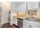 Convenient laundry area featuring granite countertop, stainless steel dishwasher, and mosaic backsplash at 501 Knights Run Ave # 6104, Tampa, FL 33602