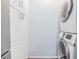 A conveniently stacked washer and dryer set next to white storage cabinets in a designated laundry room at 501 Knights Run Ave # 6104, Tampa, FL 33602